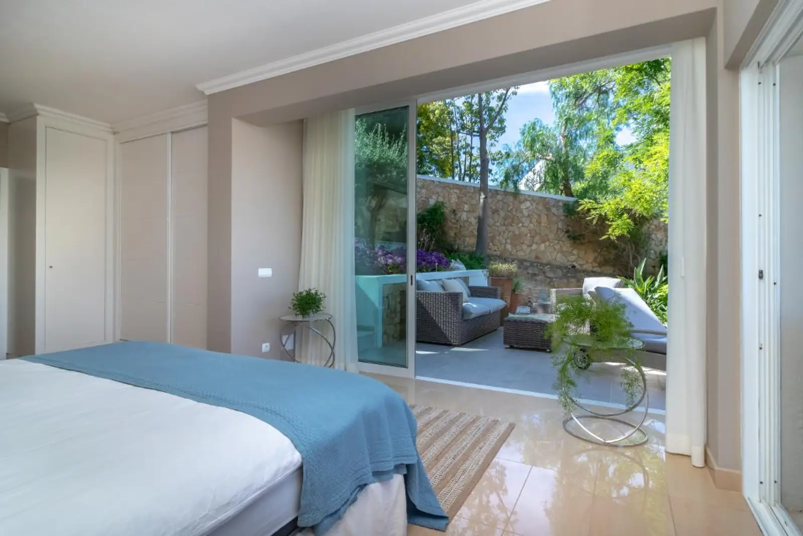 Double bedroom with fitted wardrobes and sliding doors to the terrace