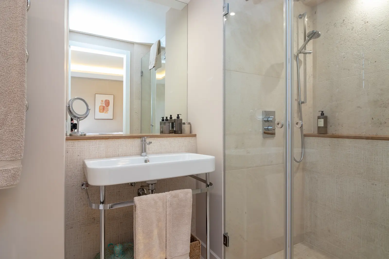 En-suite shower room with glass walk-in shower, wall-hung basin and mirror
