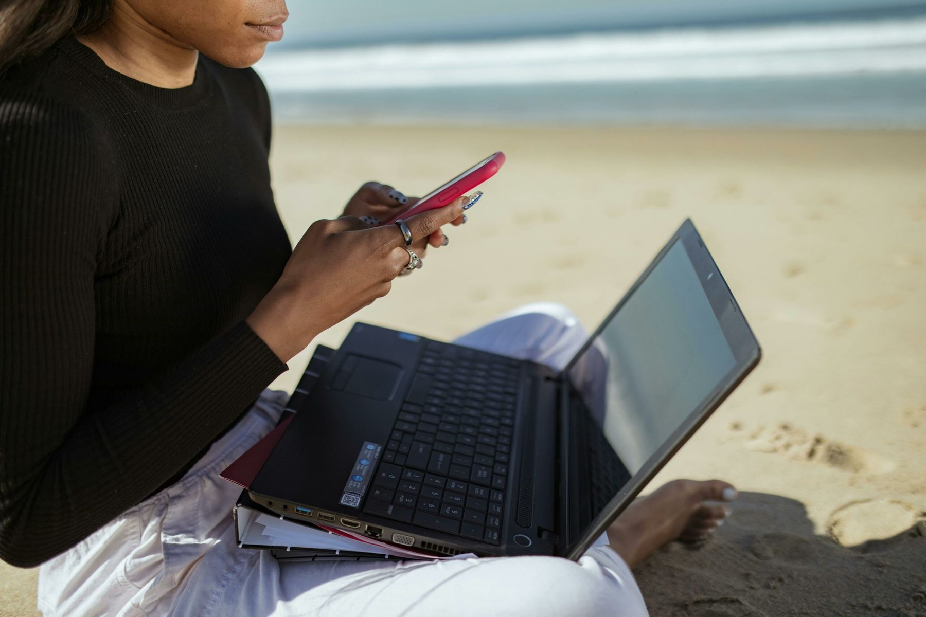 Woman in Black Long Sleeve Shirt Using Black Laptop Computer