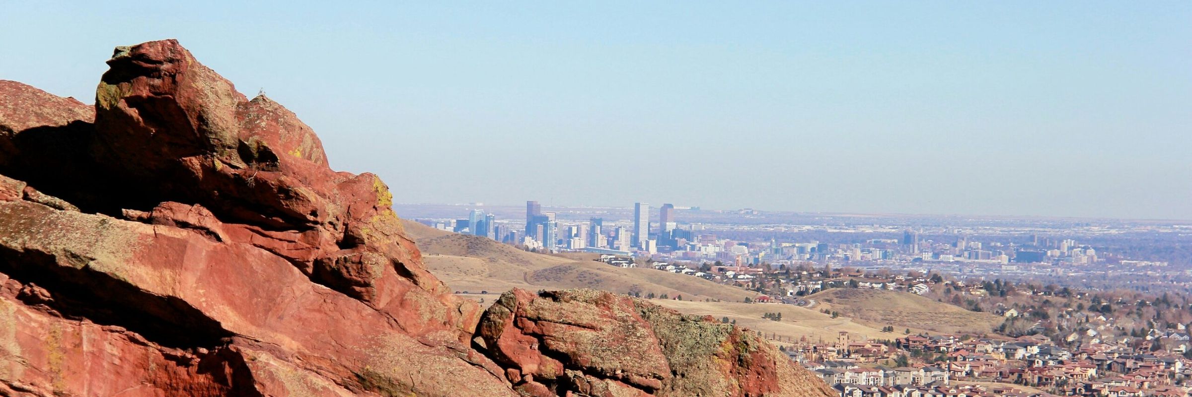 Red rock formations overlooking the Denver skyline on a clear summer day in Colorado.