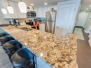 - Bright and inviting kitchen with a full suite of stainless steel appliances - Large island with bar seating for four, ideal for entertaining or quick meals - Thoughtfully designed with plenty of storage and stylish lighting to enhance your stay
