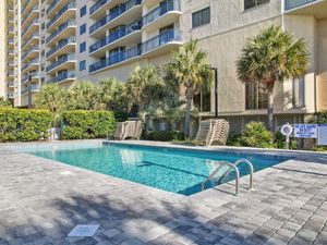 - Refreshing outdoor pool surrounded by palm trees   - Perfect for cooling off after Myrtle Beach adventures   - Lounge chairs ready for sunbathing and relaxation