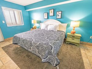 - Relax in this beautifully designed bedroom featuring a plush king sized bed - Cozy ambiance with warm lighting, soft linens, and charming bedside tables - Stylish coastal decor creates a peaceful retreat for a restful night’s sleep