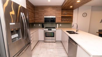 Prepare meals with ease in the modern, fully-equipped kitchen, complete with top-tier appliances and sleek finishes.