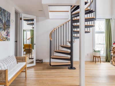 Spiral stairs lead up to the guest house loft.