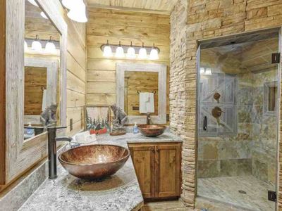 Bathroom attached to Master Suite 5. Features stone walk-in shower & double sink