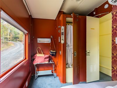 The Empire Suite equipped with a closet, bedside table, robes and slippers.