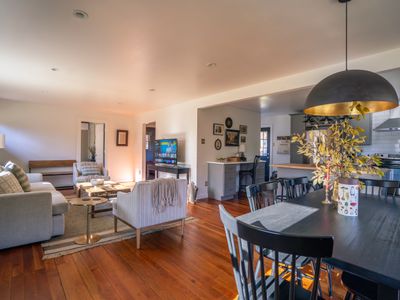 The open concept flows between the living room, dining area, and kitchen.