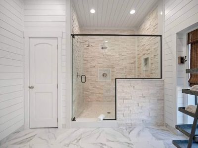 Walk-in shower with multiple shower heads.