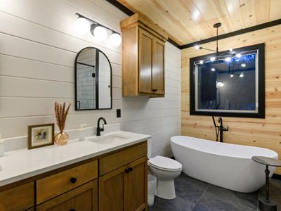 This bathroom features a double vanity and soaking tub.