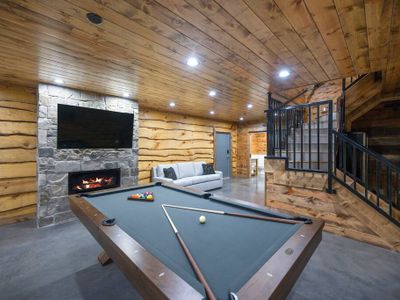 The game room with a pool table and fireplace!