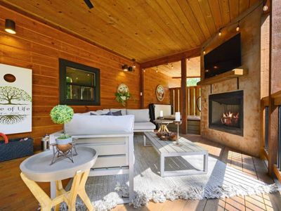 The bottom covered patio features an oversized outdoor sectional + fireplace.