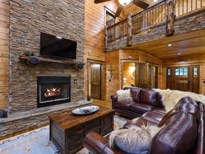 Oversized leather sectional around the stone fireplace!