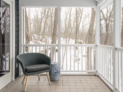 Additional seating on the screened in porch.