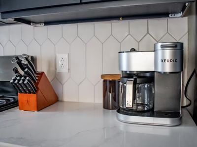 The kitchen is stocked with high quality wares like this Keurig duo coffee maker and Zwilling knife set.
