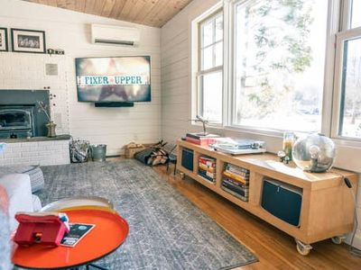 Living room includes record player with vinyl collection and Smart TV, with Sonos speakers.