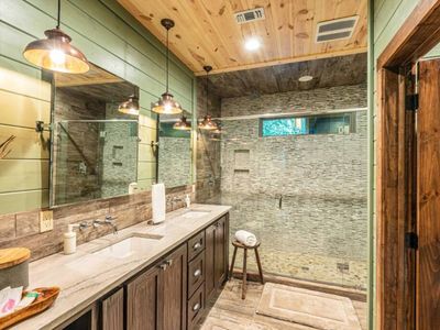 The private bathroom attached has a double vanity and a walk-in shower.