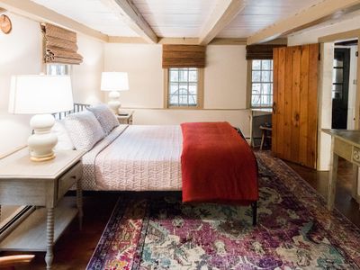 Rustic beams and decorative rugs make this bedroom a cozy retreat.