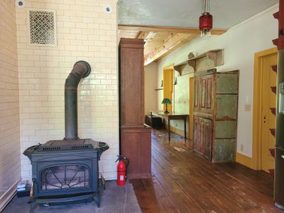 Wood stove in the kitchen leading into living room