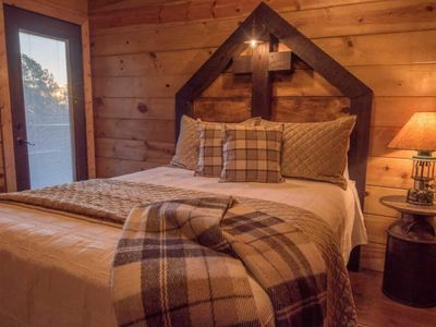 This bedroom (room 3/4 upstairs) holds a Queen bed as well as an exit to outside.