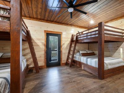 Making your way to the bottom floor, you will find the bunk room! 4 Queen beds.