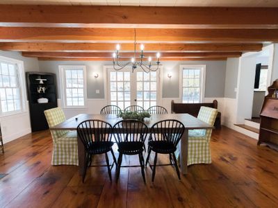 Walk into White Tail Farmhouse to an open concept dining room with large exposed wood beams throughout.