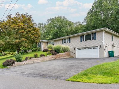 The front of the house offers ample parking for your guests. Don’t forget to say hello to our beautiful maple tree gracing the front lawn!