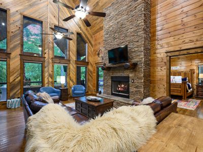 Oversized leather sectional around the stone fireplace!
