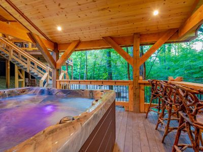 An oversized hot tub and additional seating can be found in the gazebo.
