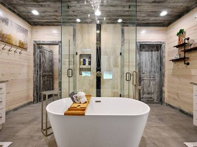 The bathroom has an oversized soaking tub as well as a walk-in shower.