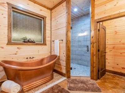 An oversized soaking tub in the private Master bath.