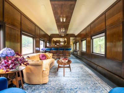 Enter into the living room, complete with a bar, projector and a big comfy chesterfield.