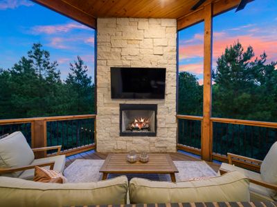 Outdoor couch and lounge seating around the gas fireplace