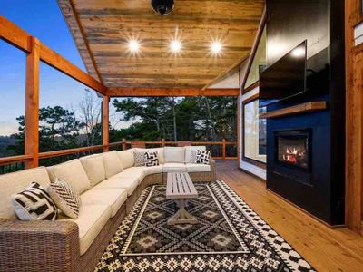 The upper level outdoor patio has an oversized sectional and gas fireplace!