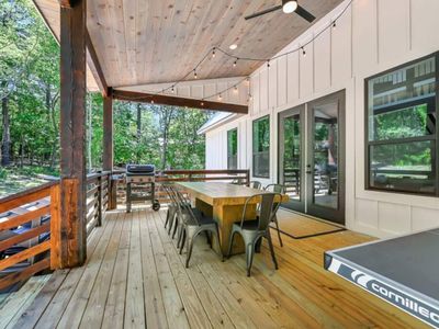 A gas grill, propane provided, is on the patio.