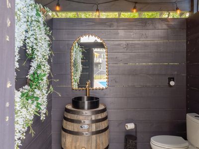 This lovely little powder room is available on the pool deck for easy access between dips!