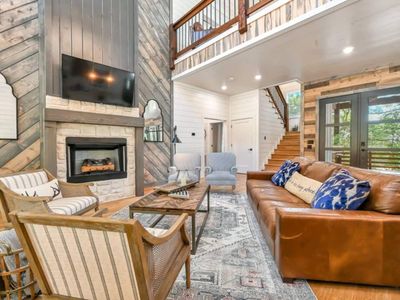 The living room is centered around the luxury fireplace and flat screen tv.