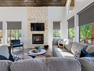 The oversized sectional and additional lounge chair sit around the gas fireplace!