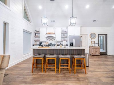 4 seats at the island in the kitchen.