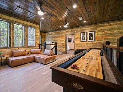 The loft/game room with lounge seating and shuffleboard.