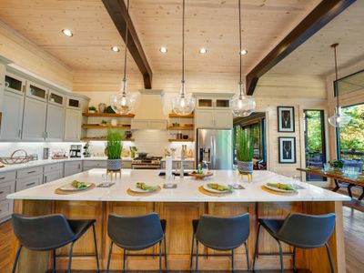 The giant island with bar seating for 4 is the heart of the kitchen—warm, bright, and designed for sharing life’s best moments.