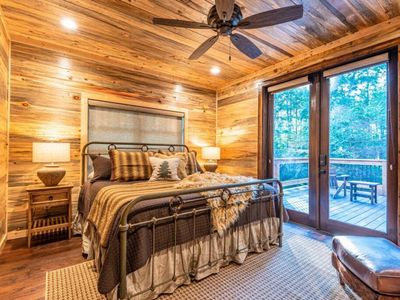 A King Suite with direct patio access and lounging chair.