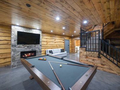 The game room with a pool table and fireplace!