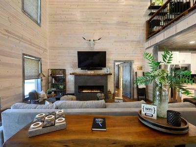 A luxury sofa sits around the fireplace and tv!