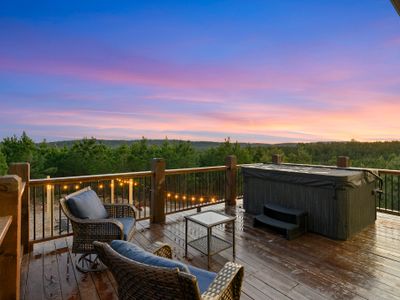 The deck is home to outdoor seating and a hot tub fitting 8 people!