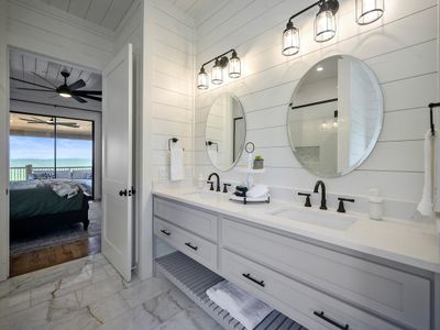 Attached private bathroom with double vanity.