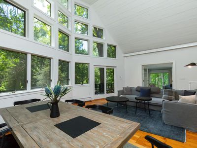 Large picture windows in the open concept living and dining room bring in so much natural lighting