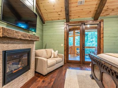 A twin sleeper sofa and fireplace along with a Smart TV.