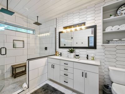 A double vanity and luxury double head rain shower.