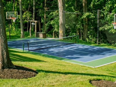 Looking from the pool deck towards the court and entrance to private hiking trail.